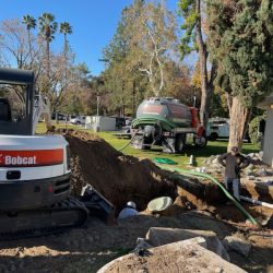 Two men working on a septic system.